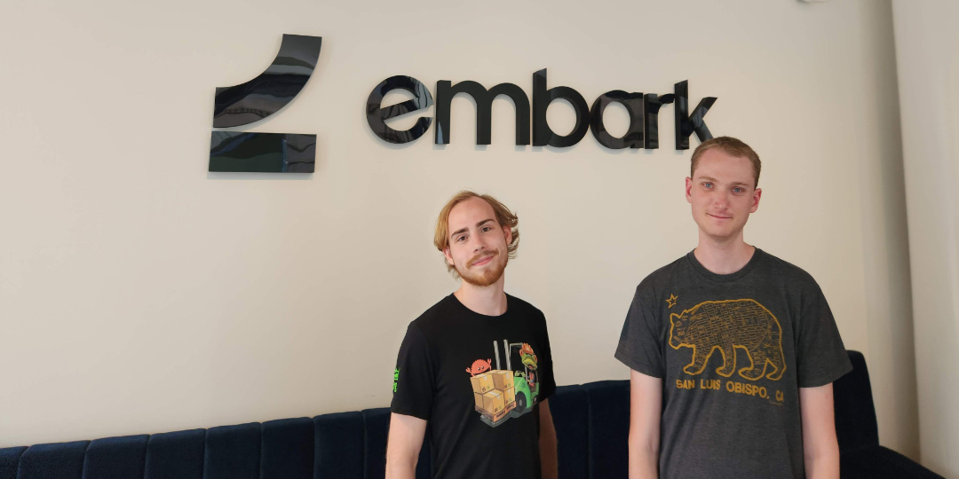 Leonard and Keavon in front of the Embark office sign